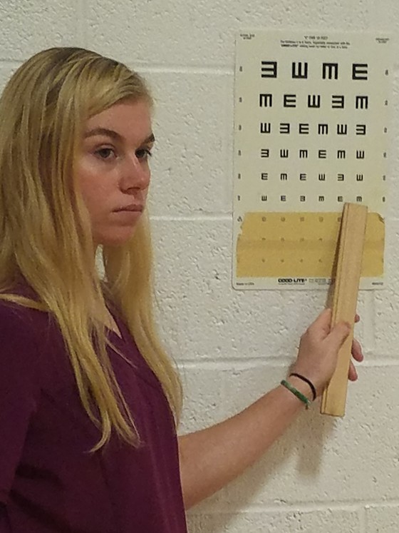 MA student assists with vision screening