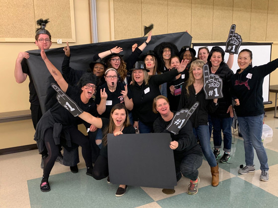 Key MS staff dressed in black for a team spirit activity.