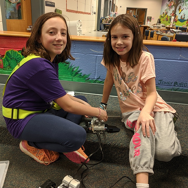 Two students working on a Lego Robot.