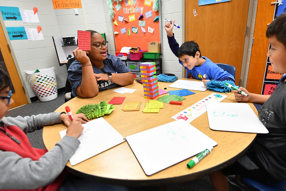 students playing board game at table