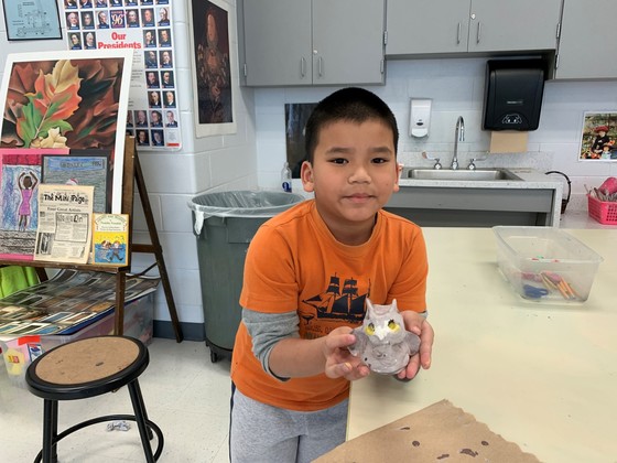 photo of student holding art project