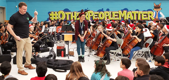 Principal Taylor performs with students at concert