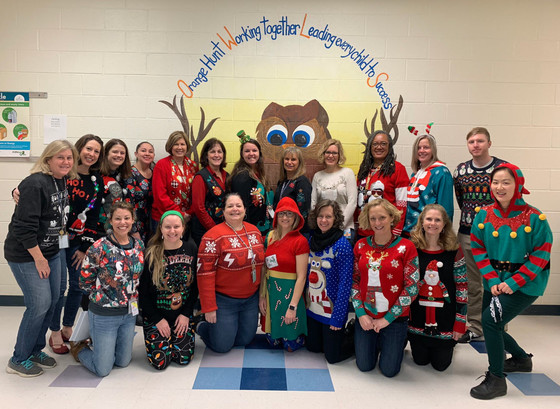 Orange Hunt ES staff wear holiday sweaters.