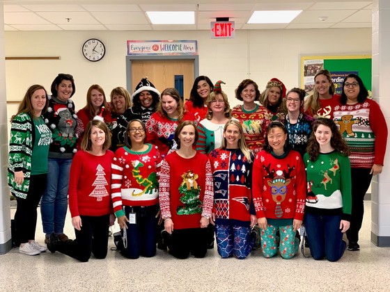 Clermont staff members pose in holiday sweaters. 