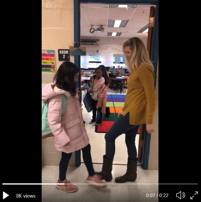 Timber Lane ES teacher does a special handshake with each student.