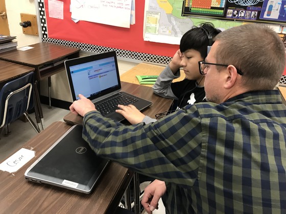 Mr. Gerber helping a student with coding