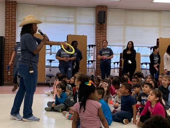 Photo of Ms. Usher presenting at the pep rally