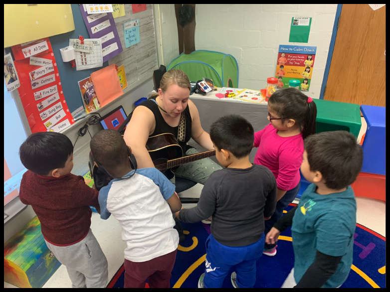 Teacher guiding students during a lesson.