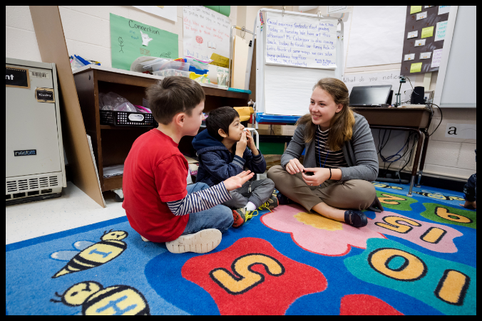 Teacher and students having a discussion.