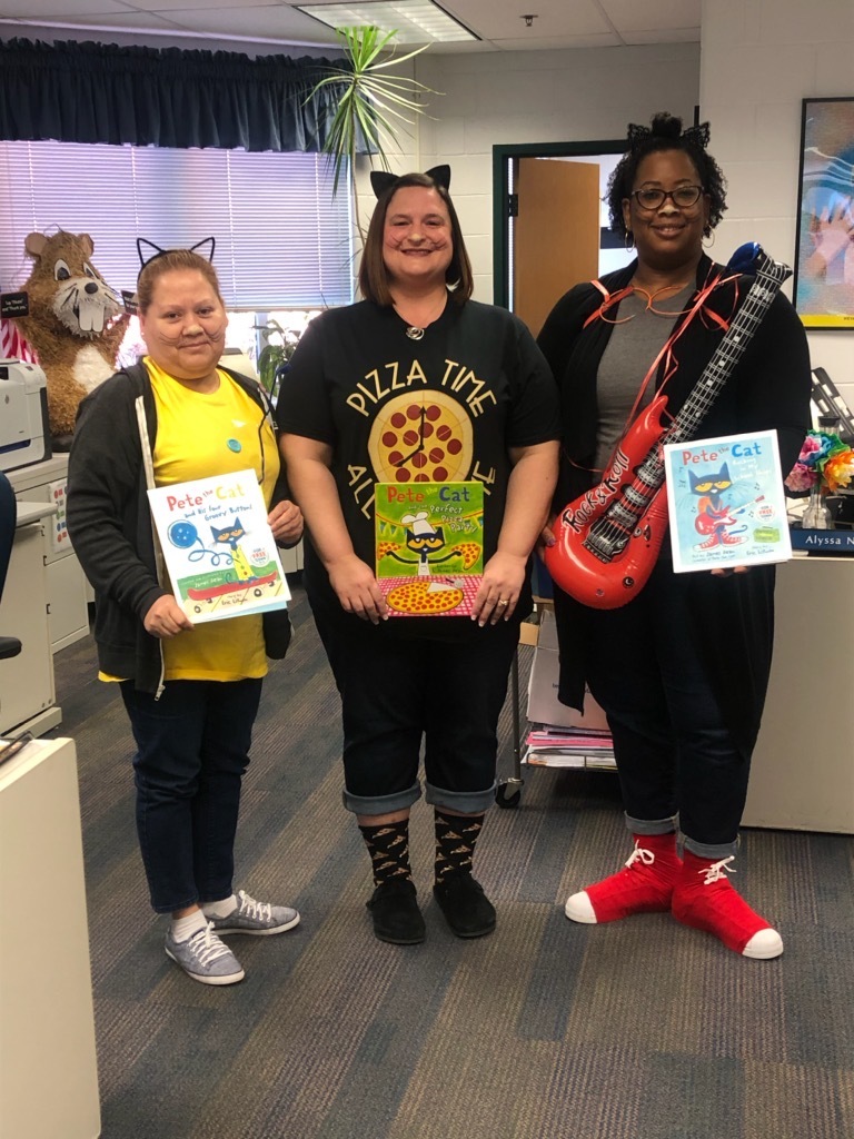 Photo of staff members in costume as Pete the Cat