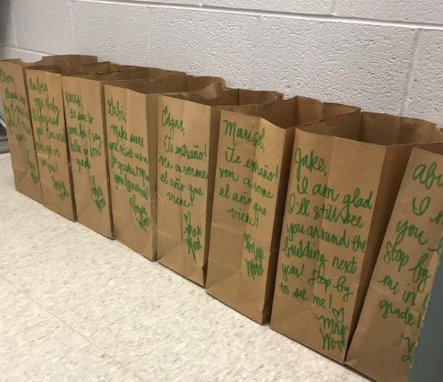 Centreville ES hallway with bags of student items packed by teachers. A nice note was left on each bag.