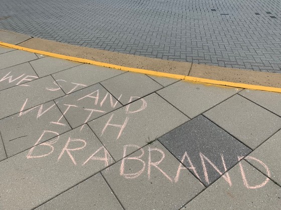Messages of support for Dr. Brabrand written in chalk in front of Gatehouse Administrative Center.