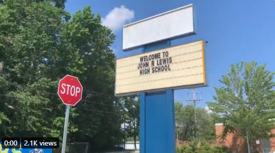 "John R. Lewis High School" on  a sign