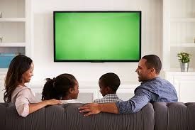 Family in front of TV screen