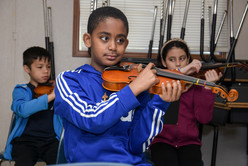 Photo of a student holding a violin