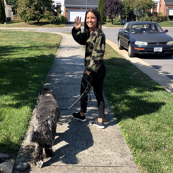 A sixth grade teacher and her dog walk to work.