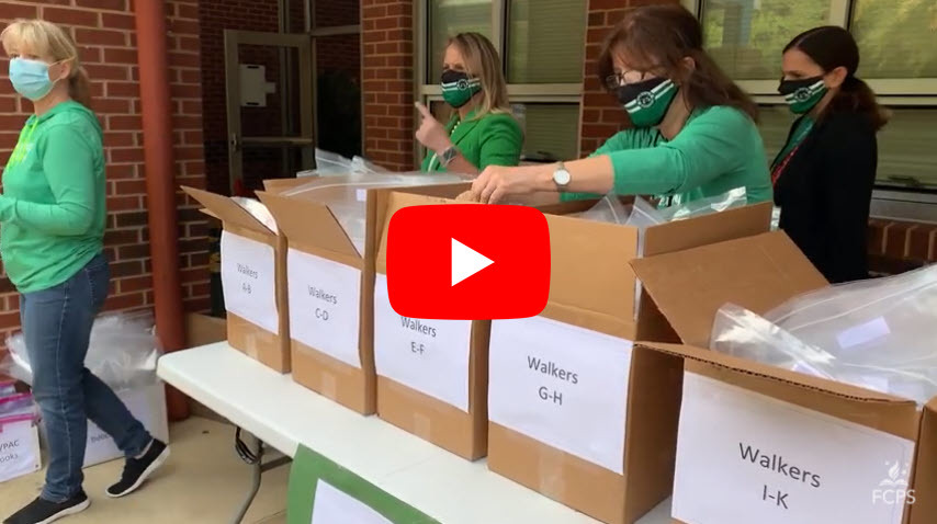 Pine Spring ES staff pack books in boxes for students.