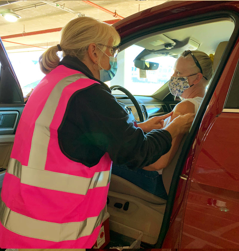 Staff member getting a flu shot during the drive-through flu clinic at Gatehouse Administration Center.