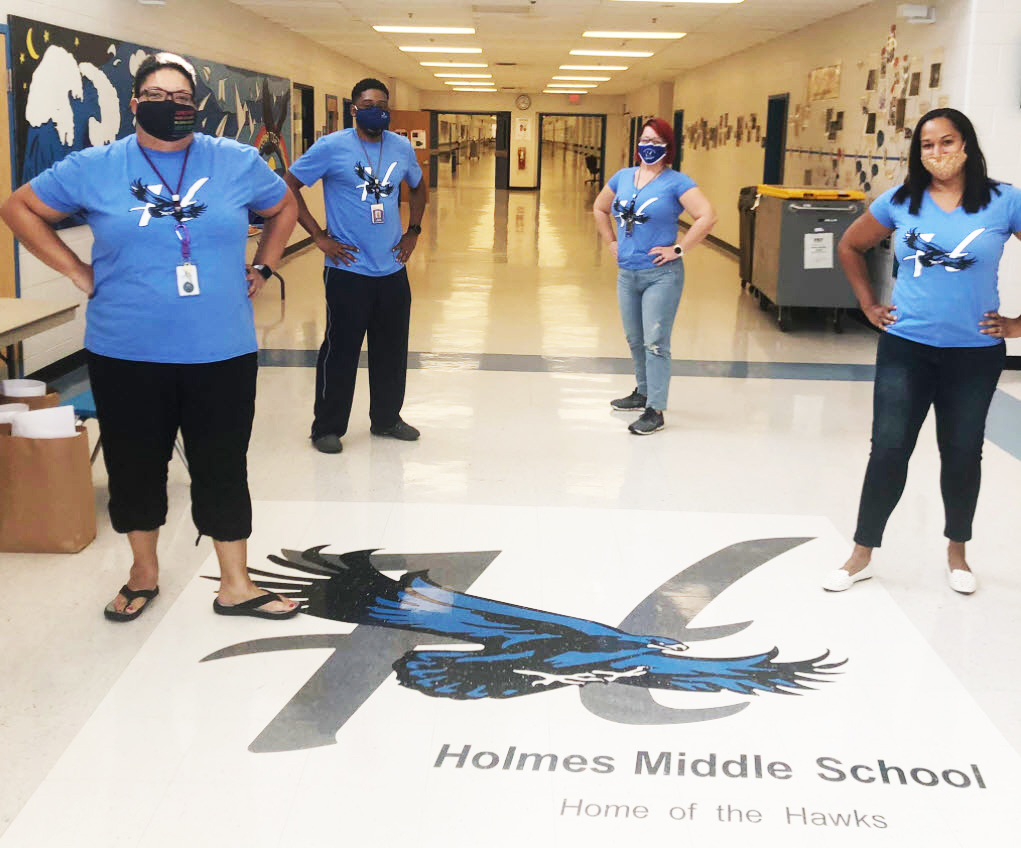 Holmes MS administrative staff standing in the school lobby.