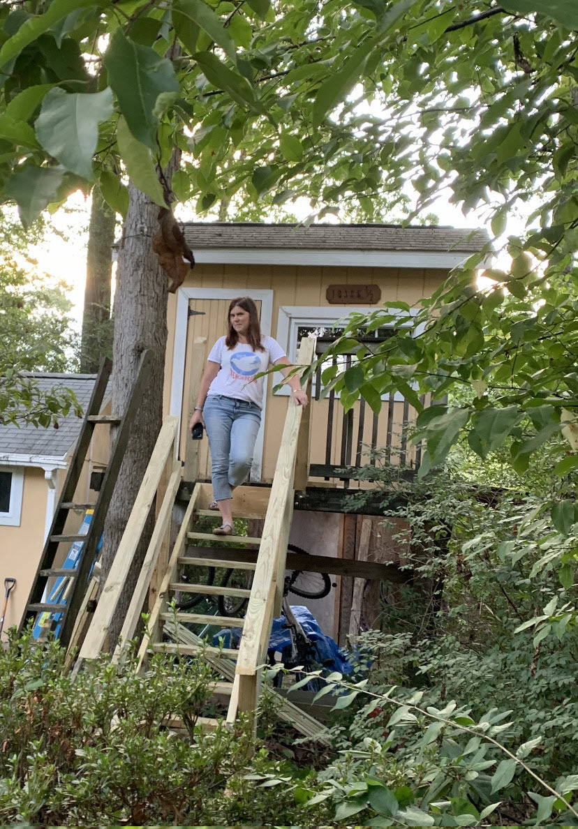 Haycock ES teacher Nellie Williams standing on the steps of her treehouse, where she works.