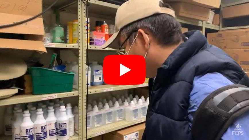 Safety Team member reviews disinfectant in a storage closet.