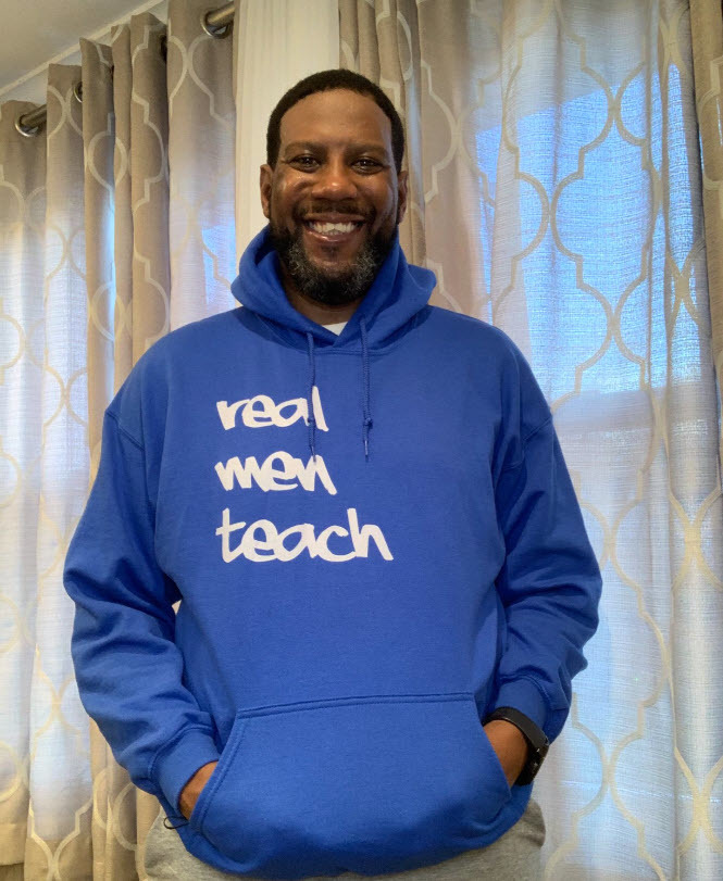 Frost MS Principal Anthony Harris wearing a hoodie with "real men teach" on it.
