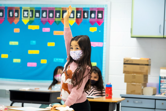 Kindergarten student raising hand