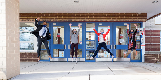 Hutchison ES staff jumping outside entrance