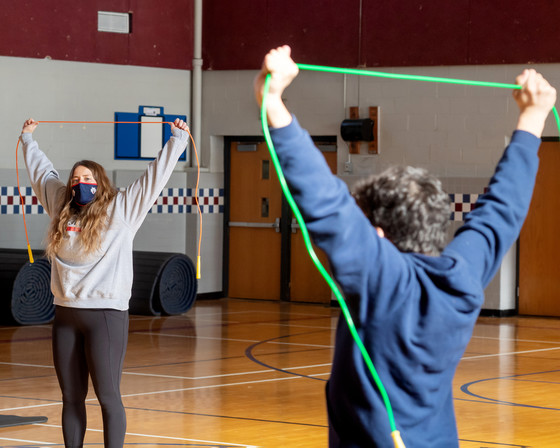 photo of teacher and student exercising with bands