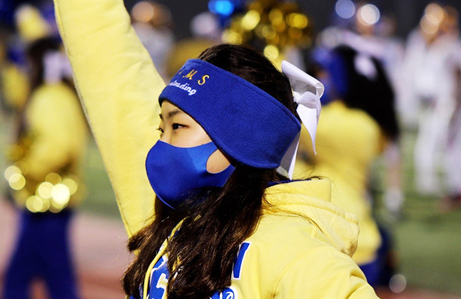photo of cheerleader with a mask