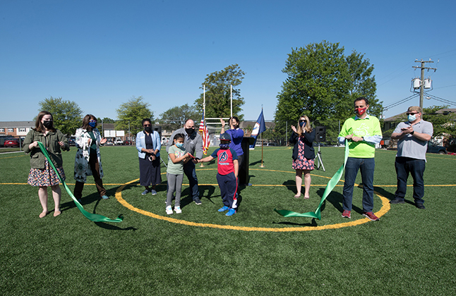 photo of ribbon cutting ceremony for turf fields at Graham Road ES Community Center