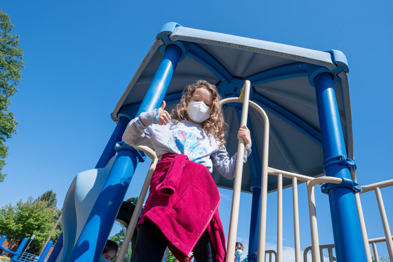 photo of girl on playground equipment