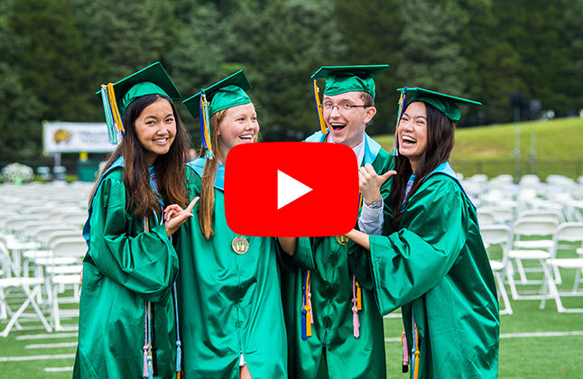 photo of grads in green graduation gowns