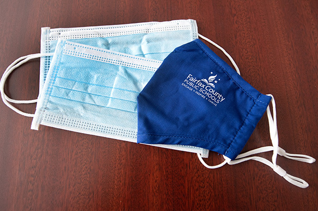 photo of disposable masks and one with FCPS logo