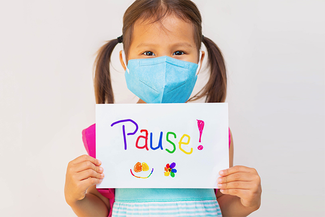 Girl holding pause sign