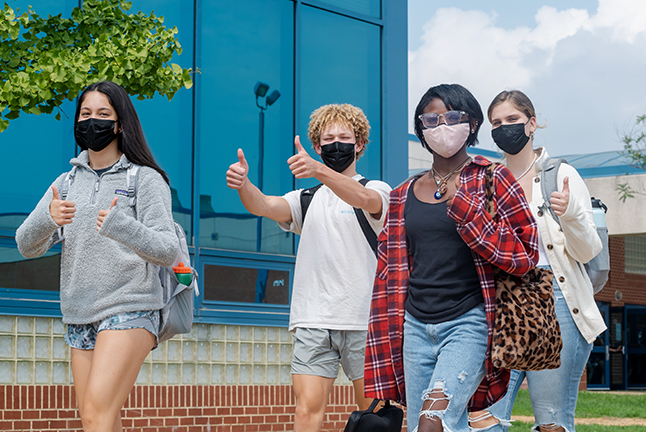 Kids giving thumbs up sign