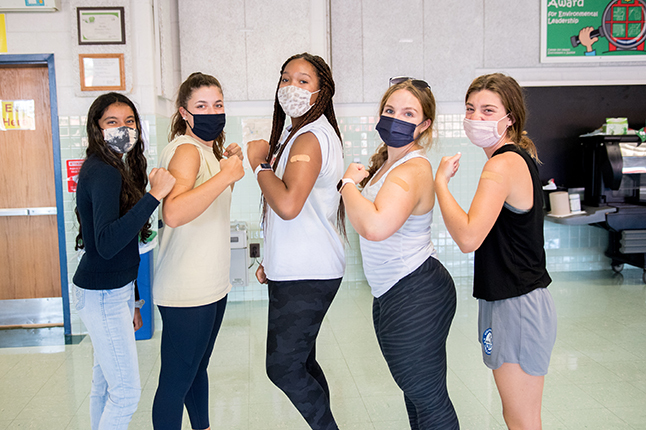 Students showing off their vaccine shots.