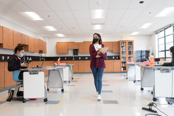 Teacher and students in a classroom.