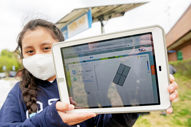 photo of girl holding up an ipad