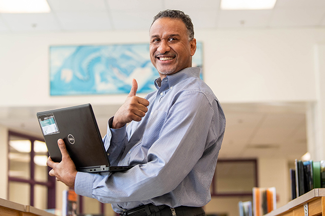 photo of Lawrence Veasley holding a laptop