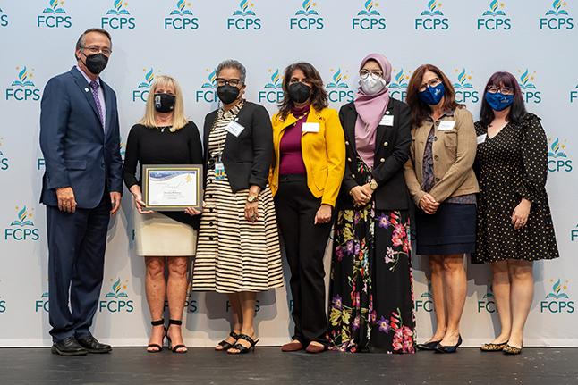 photo of Excellence Award winner Chris McKinney receiving award with Dr. Brabrand