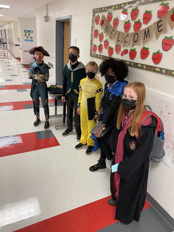 Students dressed as book characters pose in the Clermont hallway. 