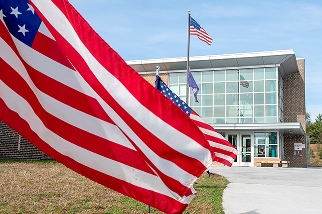 American flags wave in front of Clermont Elementary