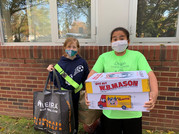 students with boxes of items to donate to homeless