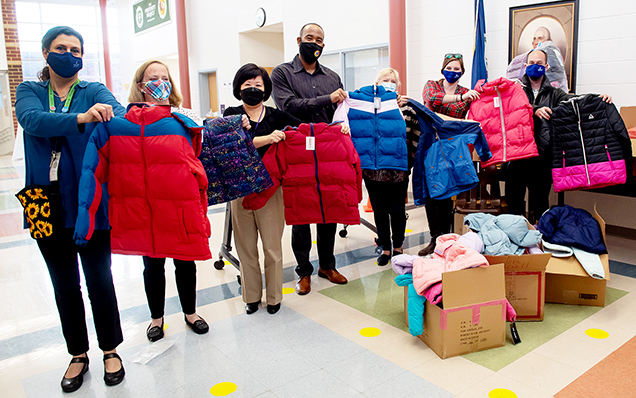 photo of staff at Hutchison ES holding up coats