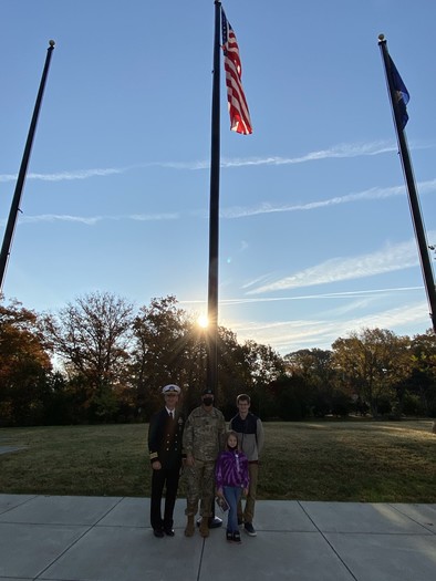Veteran family next to the USA flag.