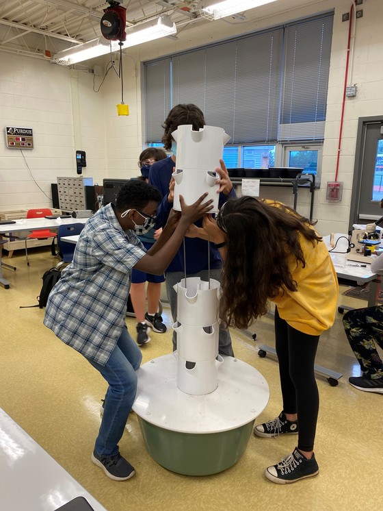 Photo of Global STEM students collaborating on an engineering design challenge.  