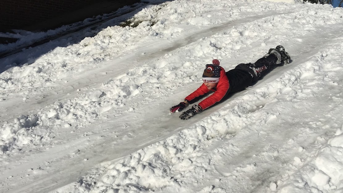Photo of a student playing in the snow
