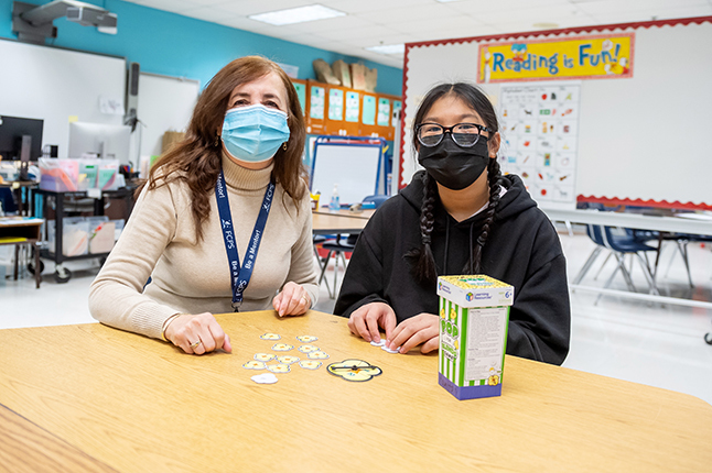 Adult mentor with student.