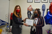 Volita Russell receiving Outstanding Leader award from Dr. Bonitatibus